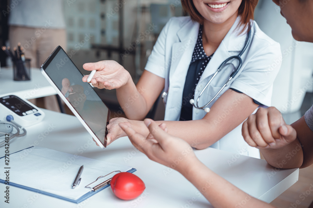 Professional doctor reporting medical results on mockup tablet white screen to male patient at clinic.Diagnostic, prevention of men diseases, medical service, consultation, Medical technology concept.